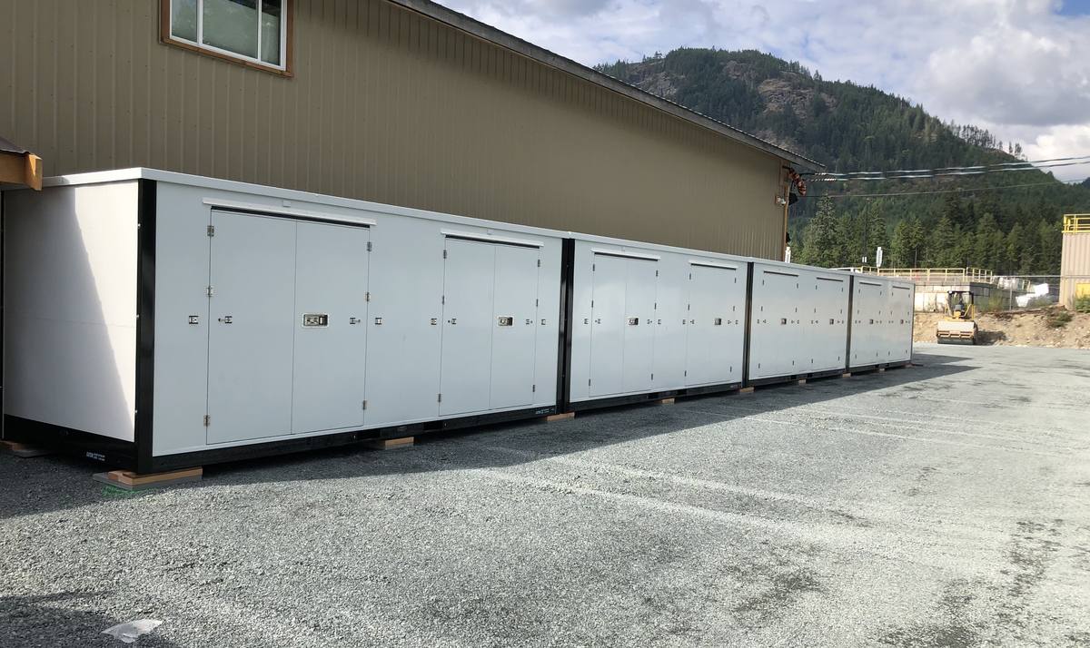 Storage units lined up beside the main building at the Karlite yard, with gravel wide enough to turn a truck and trailer